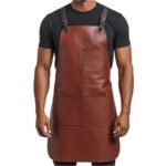 Rosso Robusto — Men's Rich Oxblood Burgundy Brown Genuine Glossy Full-Grain Cowhide Leather Heavy-Duty Adjustable Cross-Back Black Strap Gunmetal Dark-Tone Buckle Chest Pocket Dual Front Multi-Pocket Chef Barber Blacksmith Craftsman Bold Professional Workshop Utility Apron