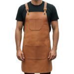 Sella Bruno — Men's Saddle Tan Hazel Brown Genuine Full-Grain Cowhide Leather Heavy-Duty Adjustable Cross-Back Strap Antique Brass Square-Ring Buckle Chest Pocket Large Single Front Pocket Chef Barber Blacksmith Craftsman Classic Professional Workshop Utility Apron