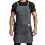 Acciaio Tattico — Men's Gunmetal Steel Grey Genuine Waxed Full-Grain Cowhide Leather Heavy-Duty Adjustable Straight Cross-Back Strap Dark Gunmetal-Tone Buckle Large Chest Flap Pocket Zipper Side Pocket Dual Lower Tool Multi-Pocket Mechanic Chef Barber Blacksmith Carpenter Craftsman Tactical Heavy-Duty Workshop Utility Apron
