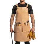 Crudo Pioniere — Men's Pale Natural Beige Buff Genuine Thick Full-Grain Cowhide Leather Heavy-Duty Adjustable Cross-Back Tan Leather Strap Leather Loop Buckle Quad Front Tool Pocket Hammer Loop Brush Holder Wide Lower Panel Chef Barber Blacksmith Carpenter Woodworker Craftsman Rugged Pioneer Workshop Utility Apron