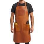 Ambra Costruttore — Men's Bright Amber Orange Tan Genuine Full-Grain Cowhide Leather Heavy-Duty Adjustable Straight Neck Strap Chest Patch Pocket Dual Lower Side Tool Pocket Plier Holder Screwdriver Slot Clean Center Panel Mechanic Carpenter Electrician Blacksmith Craftsman Rugged Heavy-Duty Professional Workshop Utility Apron