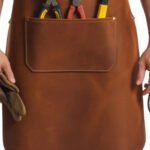 Castagno Artigiano — Men's Rich Chestnut Cognac Brown Genuine Distressed Full-Grain Cowhide Leather Heavy-Duty Adjustable Cross-Back Strap No-Buckle Leather Tie Fastening Triple Lower Tool Pocket Plier Holder Hammer Loop Screwdriver Slot Large Center Panel Carpenter Blacksmith Woodworker Mechanic Craftsman Rugged Distressed Professional Workshop Utility Apron - Image 2
