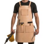 Grezzo Fabbro — Men's Pale Natural Raw Undyed Beige Genuine Thick Full-Grain Cowhide Leather Heavy-Duty Adjustable Cross-Back Tan Leather Strap Leather Loop Ring Fastening Chest Patch Pocket Triple Lower Tool Pocket Hammer Slot Brush Holder Drill Gun Loop Welder Carpenter Blacksmith Farrier Woodworker Craftsman Raw Natural Heavy-Duty Professional Workshop Utility Apron