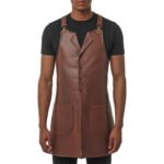 Bruno Sartoriale — Men's Warm Medium Brown Cognac Genuine Smooth Full-Grain Cowhide Leather Tailored Waistcoat-Style Lapel Collar Four-Button Front Fastening Adjustable Cross-Back Strap Gold Hardware Clip Contrast Edge Stitch Detail Dual Lower Patch Pocket Long Full-Length Panel Chef Barber Sommelier Stylist Maître Craftsman Elegant Tailored Fashion-Forward Professional Salon Restaurant Utility Apron