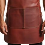 Castagno Bottega — Men's Rich Chestnut Brown Genuine Full-Grain Cowhide Leather Heavy-Duty Adjustable Cross-Back Strap Silver-Tone Clip Buckle Zip Chest Pocket Large Front Pocket Chef Barber Woodworker Craftsman Professional Workshop Utility Apron - Image 2